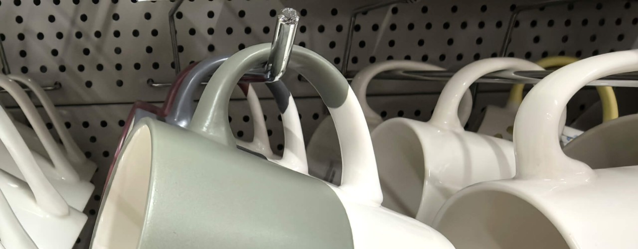 A pegboard is a flat panel with regularly spaced holes that let you insert pegs, metal or plastic hooks used to hang products.