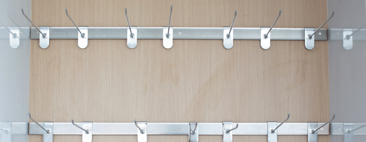 Organised slatwall display using euro hooks for retail products in a UK store.