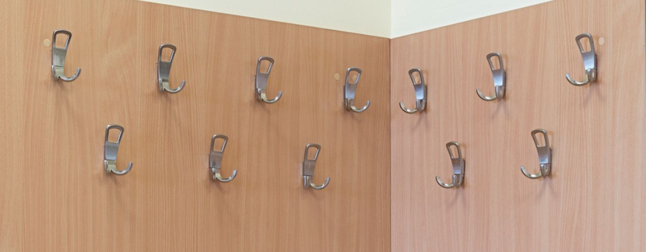 Retail shop wall display using slatwall hooks to organise products neatly