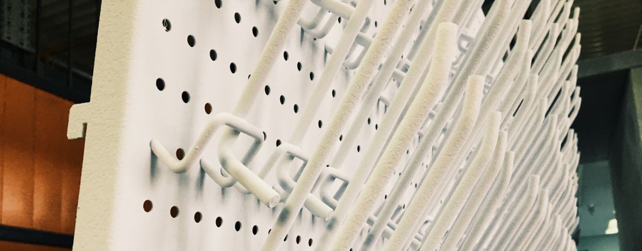 Retail wall display using pegboard system to organise products efficiently