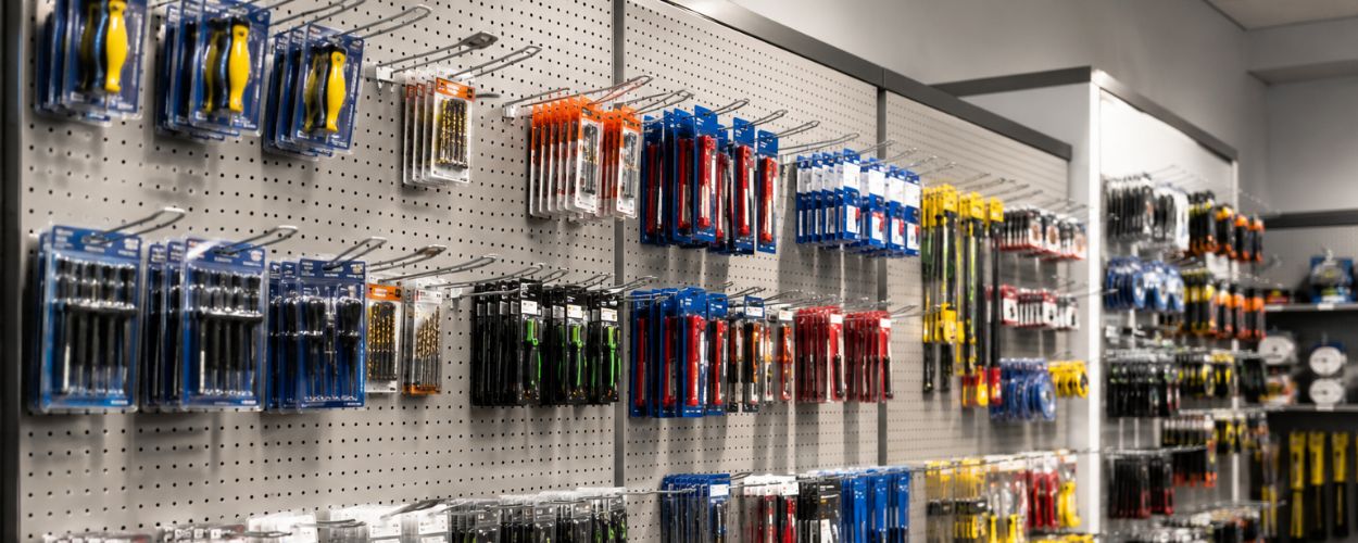 Retail pegboard display with organised hooks and neatly arranged merchandise in a commercial store